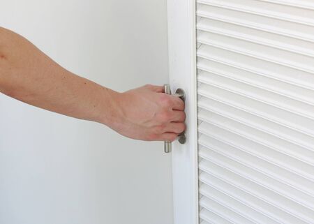 hand close the door of storage roomの写真素材