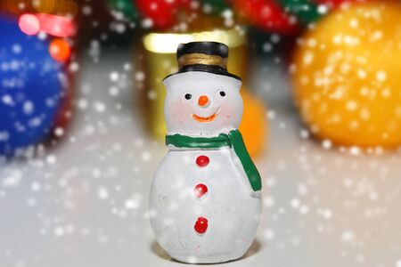 Christmas background, close up of snow man on snow and bokeh backgroundの写真素材