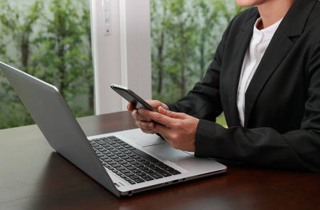 Businesswomen use smartphone for the work in the workplace