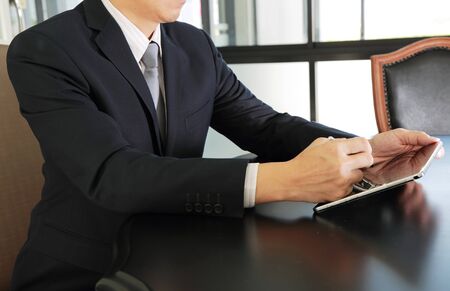Businessman working with Tablet device at the meetingの写真素材