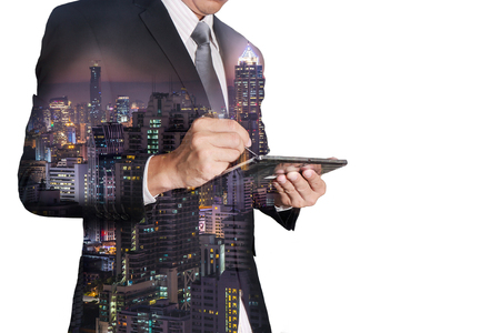 Double exposure of businessman working with tablet,  night cityの写真素材