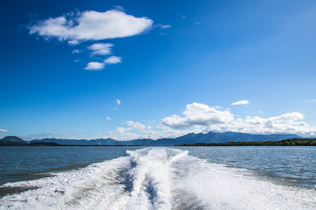 wake of a passenger ship , blue sky and cloudsの写真素材