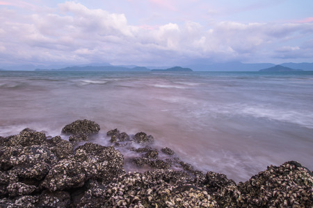 Waves toward the rocks in the eveningの写真素材