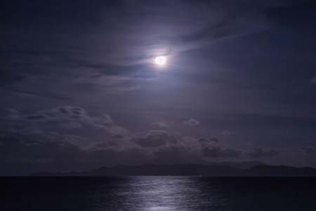 Full moon with clouds and sky over the seaの写真素材