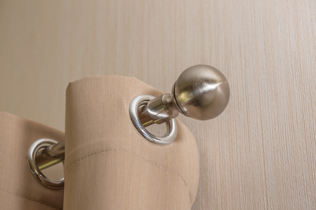 close up of steel knob and Cream colored curtainsの写真素材