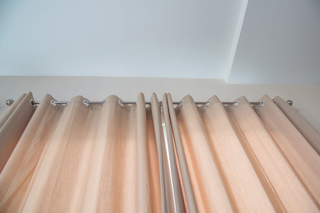 Bottom view of green colored curtains In stainless steel rail is modern style.の写真素材