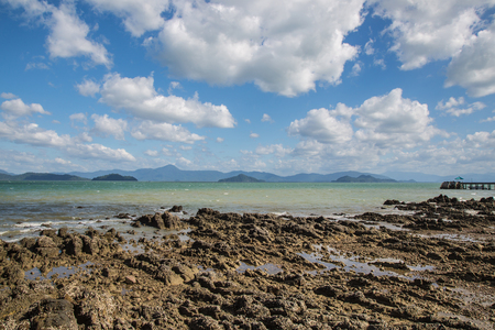 Nature of rocks on the beach under beautiful of clouds and blue sky.の写真素材