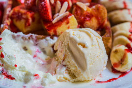 Close up of melting vanilla ice cream with Strawberry toast, ice cream sherbet and banana.の写真素材