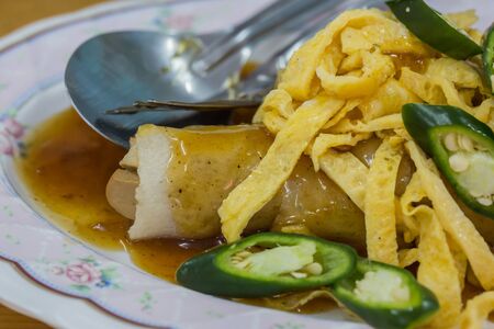 Close up of spring rolls with sweet sauce, vegetables and in noodle tube.の写真素材