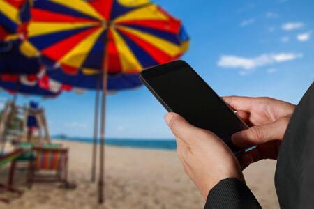 double exposure of woman hand hold and touch screen smart phone, tablet,cellphone and cityscape daytimeの写真素材