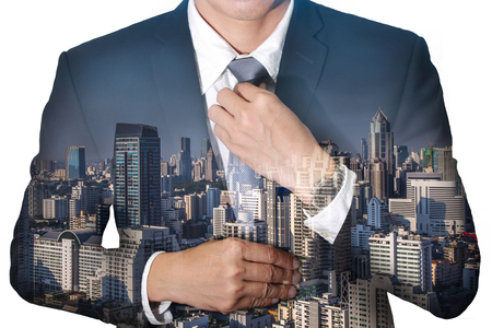Business  man held necktie dress to look good and city on daytime as Readiness concept.の写真素材