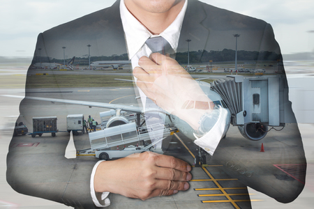 Business  man held necktie dress to look good and and airport on motion background as Travel and Transportation concept.の写真素材