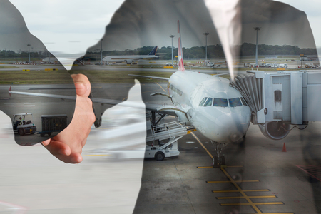 Double exposure of handshake and airport on motion background as partnership and transportation concept.の写真素材