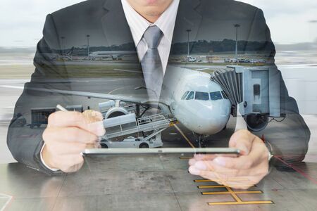 Double exposure of business man working with tablet and airport on motion background as Communication and Transportation concept.の写真素材