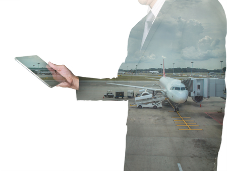Double exposure of business man looking the tablet and airport as Communication and Transportation concept.の写真素材