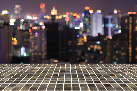 Square tile top on background of bokeh abstract of night city - can used for display or montage your productsの写真素材
