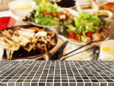 Square tile top on background of blurred barbecue, Vegetable and Other food - can used for display or montage your productsの写真素材