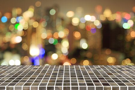 Square tile top on blur night bokeh background - can be used for display or montage your productsの写真素材