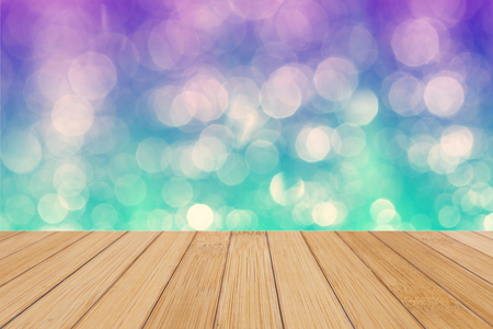 Bamboo wooden top on background of blurred purple, blue and green bokeh - can used for display or montage your productsの写真素材