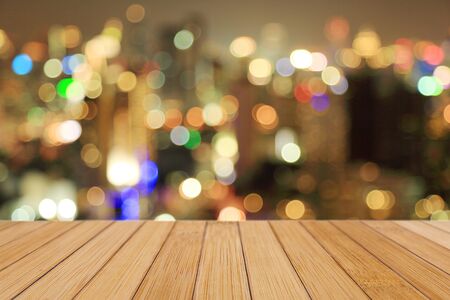 Wooden top on background of blurred night bokeh - can used for display or montage your productsの写真素材