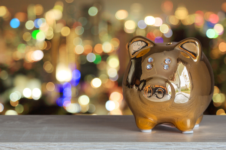 Golden piggy bank with bokeh background, abstract background to time to start to saving or solution for keep money.の写真素材