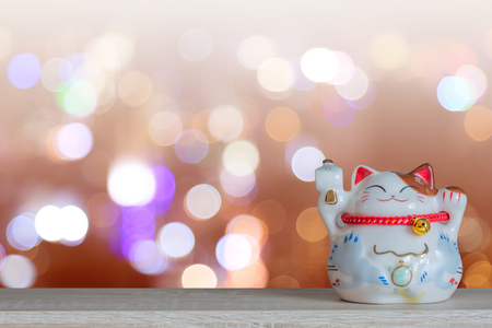 Lucky cat piggy bank with vintage tone bokeh background, abstract background to time to start to saving or lucky for keep money concept.の写真素材