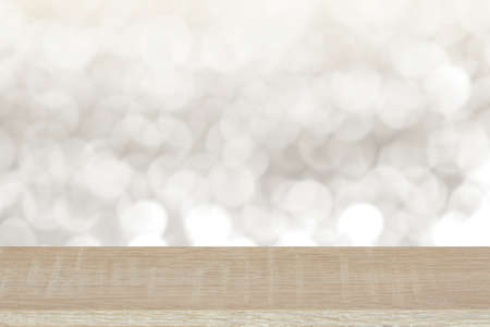 Wooden top on background of blurred white bokeh background - can used for display or montage your products or your business.の写真素材
