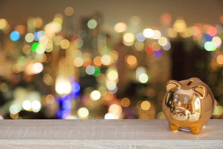 Golden piggy bank with colorful bokeh background, abstract background to time to start to saving or solution for keep money concept.の写真素材