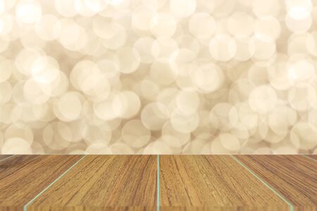 Wooden top on background of blurred brown bokeh - can used for display or montage your productsの写真素材
