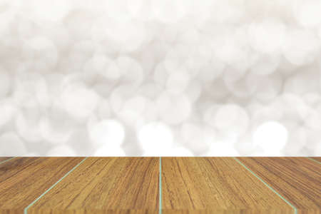 Wooden top on background of blurred abstract white bokeh background - can used for display or montage your products.の写真素材