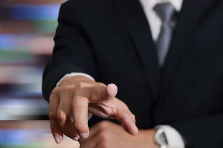 Businessman hand touching empty virtual screen, modern business background concept - can be used for montage your text or pictures.の写真素材