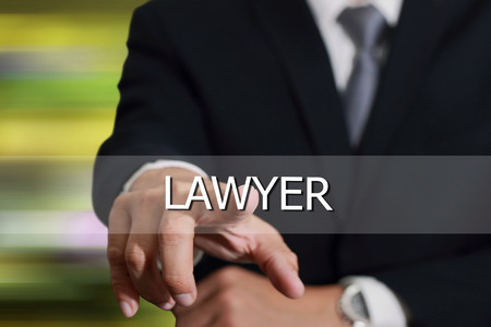 Businessman hand touching lawyer sign on virtual screen as justice concept.の写真素材