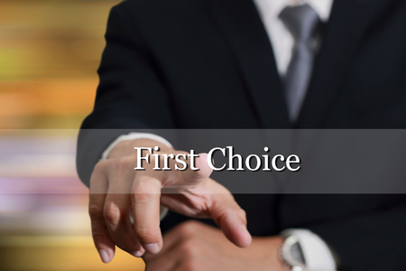 Businessman hand touching First Choice sign on virtual screen as Good Options concept.の写真素材