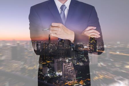 Double exposure of business man think idea and night cityscape on camera zoom background  as vision of leader concept.の写真素材