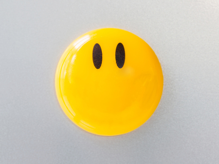 Yellow magnet on paper background, abstract background.の写真素材