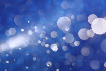 Abstract Light bokeh on blue background caused by spray water.の写真素材