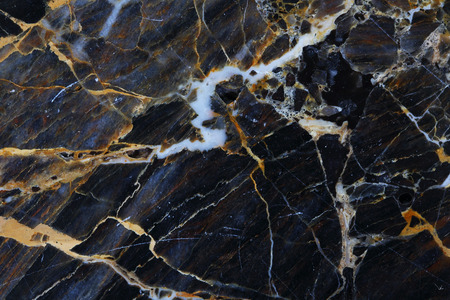 Gold, yellow and white patterned natural structure of dark gray marble texture background.の写真素材