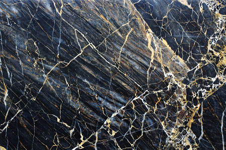 Gold, yellow and white patterned natural structure of dark marble texture background.の写真素材