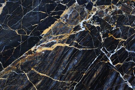 Yellow and white patterned natural of dark marble background texture.の写真素材