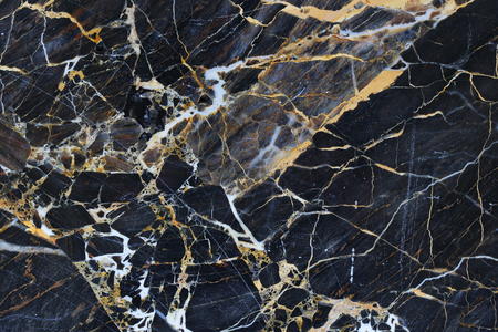 Gold, yellow and white patterned natural structure of dark gray marble texture for design.の写真素材