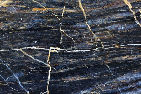 Gold and white patterned natural of dark gray marble texture.の写真素材