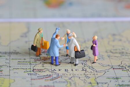 Selective focus of miniature businessman handshake on Africa map background as Journey and travel Conceptの写真素材