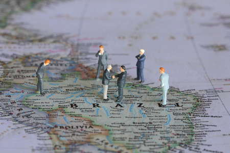 Selective focus of miniature businessman handshake on Brazil map background as commitment, agreement and partnership Conceptの写真素材