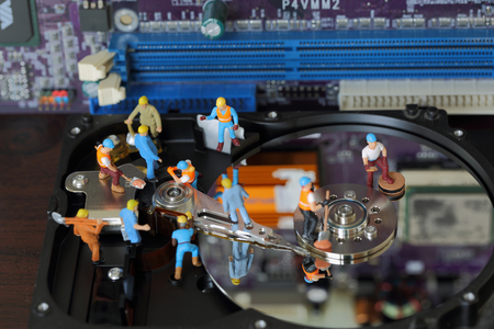 Selective focus of miniature engineer and worker maintenance hard disk and fixed problem hard disk...