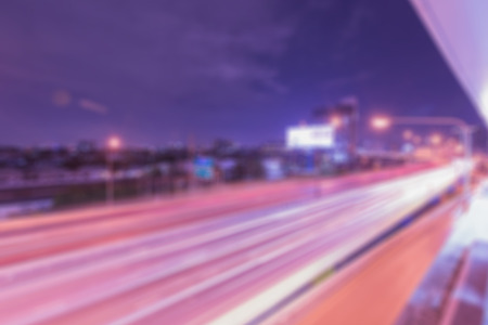 Blur abstract bokeh background in light on night street, blue and purple toneの写真素材