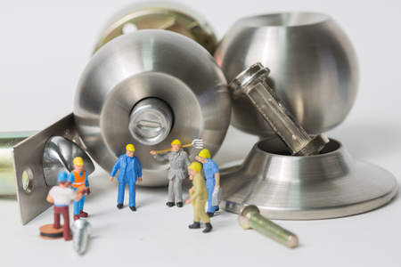 Selective focus of miniature engineer and worker meeting and discuss of manufacturing Stainless steel round ball door knob component as Locksmith, business and industrial concept.の写真素材