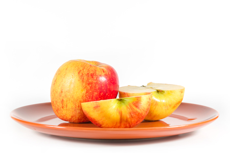 Apples on a brown dish isolated on white background.の写真素材