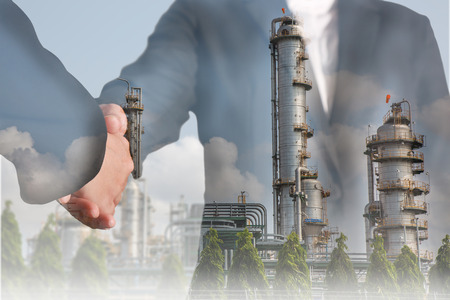Double exposure of handshake and Electric Generating Factory as teamwork and energy concept.の写真素材