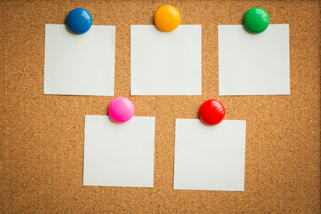 colorful magnet put on white paper on cork board texture or background for note, input text