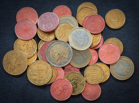 Top view Euro coins on dark gray suede as business, money, banking, currency and exchange rate...